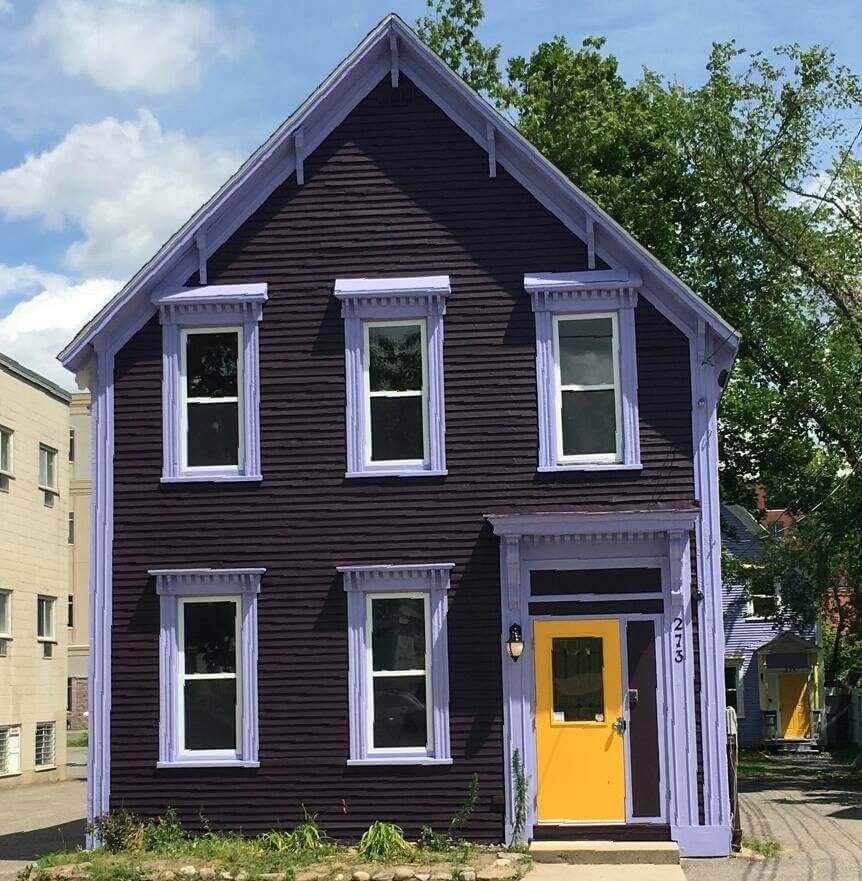 Brunswick House: A dark burgundy and yellow house