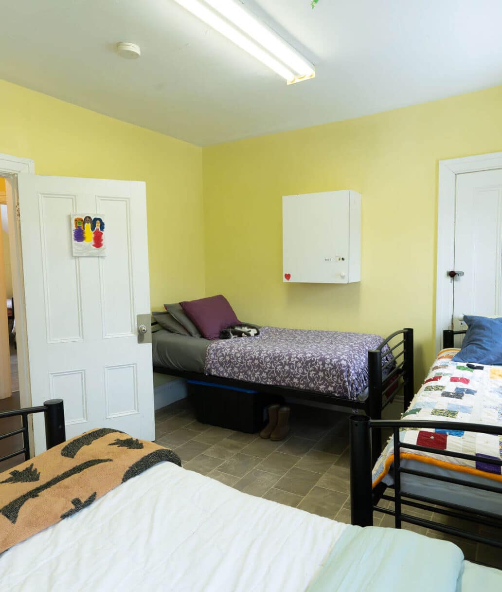 Grace House: A clean bedroom featuring three beds