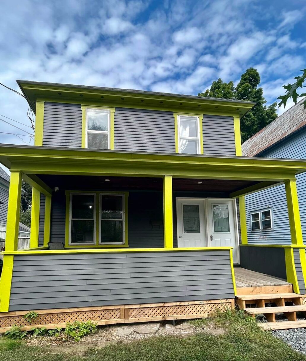 A grey and lime green house