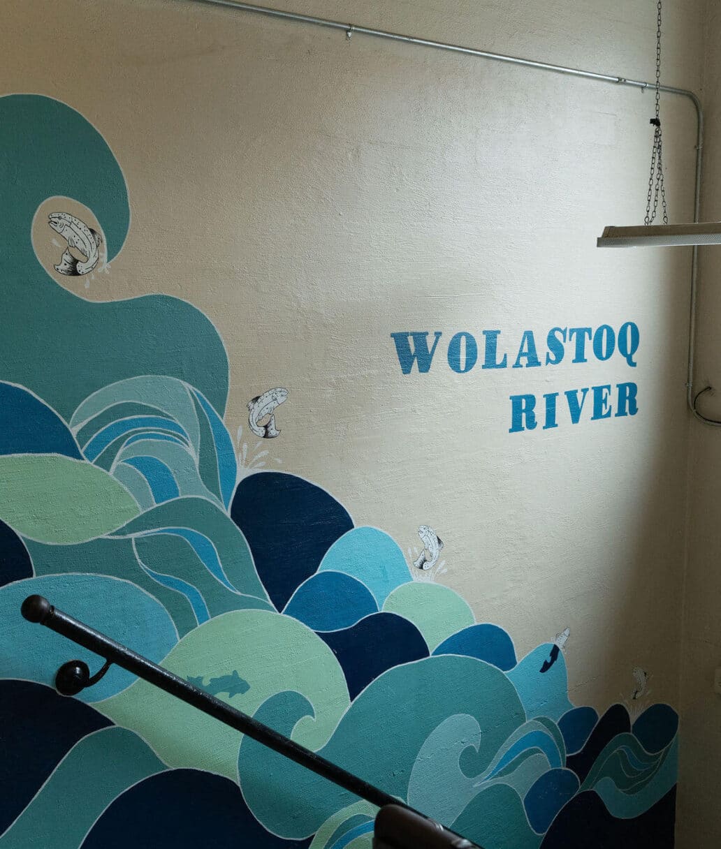 A Wolastoq River mural painting on a concrete wall