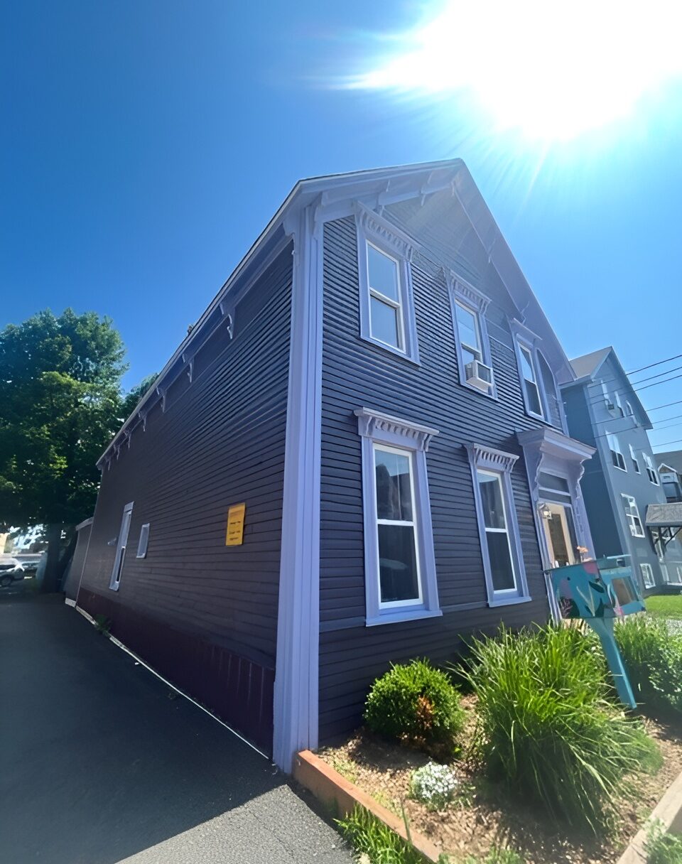 Brunswick House: A dark burgundy and yellow house