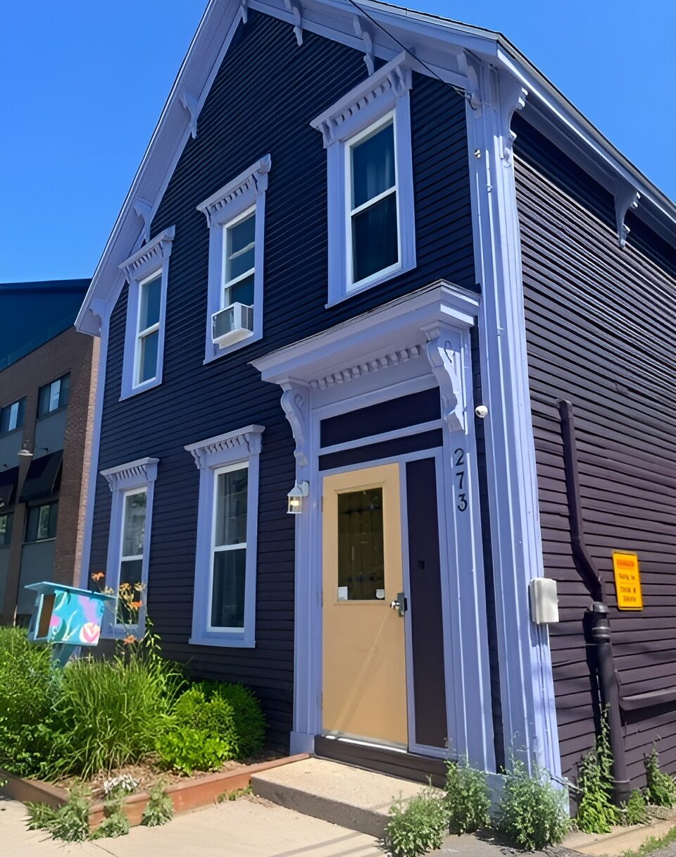 Brunswick House: A dark burgundy and yellow house