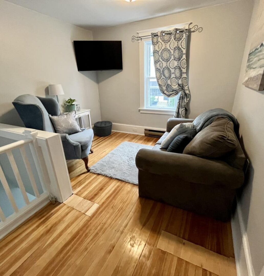 Mim's House: A living area with sofa, chair, and TV