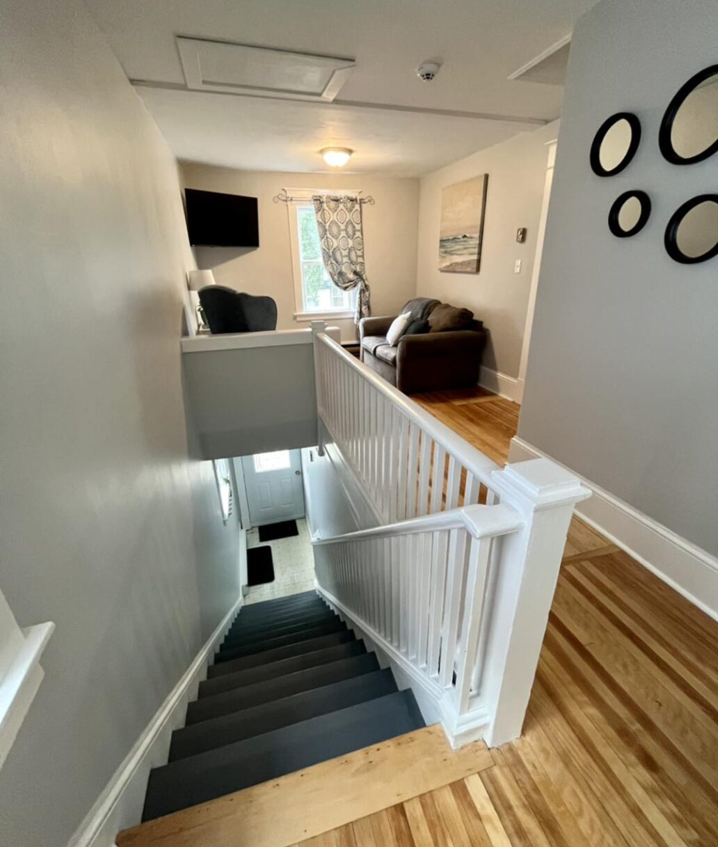 Mim's House: A view from the top of the stairs looking over the entertainment area and entrance